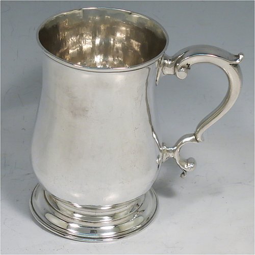 An Antique Georgian Sterling Silver half-pint tankard, having a plain round baluster body, a scroll handle, and sitting on a collet foot. Made by John Payne of London in 1759. The dimensions of this fine hand-made antique silver half-pint mug / tankard are height 10 cms (4 inches), diameter at top 7 cms (2.75 inches), and it weighs approx. 214g (6.9 troy ounces).   