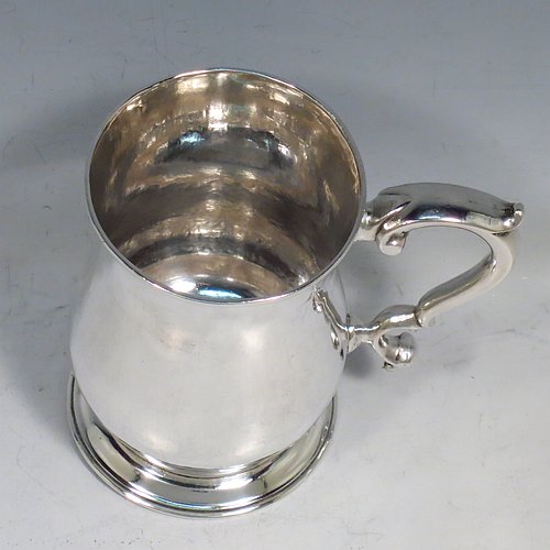 An Antique Georgian Sterling Silver half-pint tankard, having a plain round baluster body, a scroll handle, and sitting on a collet foot. Made by John Payne of London in 1759. The dimensions of this fine hand-made antique silver half-pint mug / tankard are height 10 cms (4 inches), diameter at top 7 cms (2.75 inches), and it weighs approx. 214g (6.9 troy ounces).   