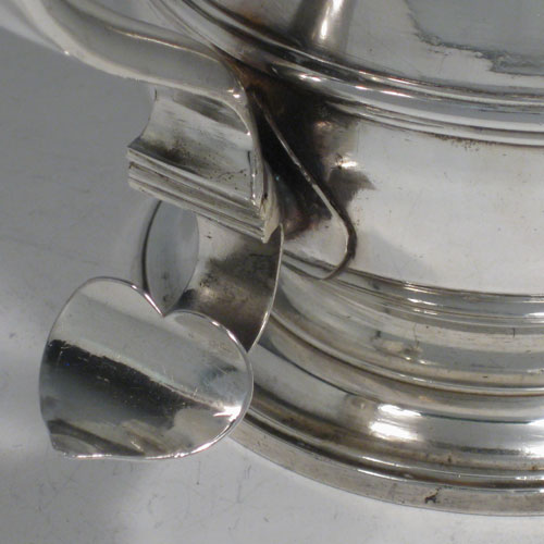 Antique Georgian sterling silver lidded quart tankard, having a plain bellied body, a hinged dome lid with thumb-piece, a scroll handle, sitting on a pedestal foot. Made by William Cripps of London in 1760. Weight approx. 758g (24.5 troy ounces). Please note that this piece has a small part-crest on the front of the body.