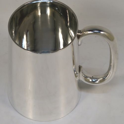 A very handsome Antique Sterling Silver pint mug or tankard, having a plain round body with straight tapering sides, a plain loop side-handle, and all sitting on a flat base. This elegant silver tankard or mug was made by Carrington and Co., of London in 1918. The dimensions of this fine hand-made antique silver pint mug are height 12 cms (4.75 inches), diameter at top 7.5 cms (3 inches), and it weighs approx. 281g (9 troy ounces).   