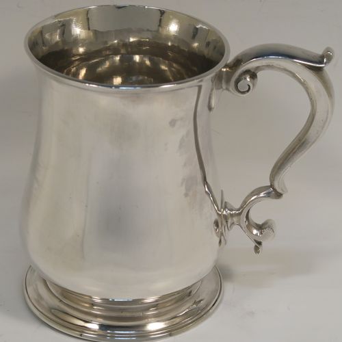 A very handsome Antique Georgian George II Sterling Silver pint tankard, having a plain round bellied body, a scroll handle with thumb-piece, and sitting on a pedestal foot. This elegant antique silver mug was made by Henry Bond of London in 1747. The dimensions of this fine hand-made antique silver pint mug or tankard are height 12 cms (4.75 inches), diameter at top 8.5 cms (3.3 inches), and it weighs approx. 441g (14 troy ounces).   