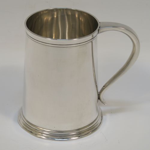 A very handsome Antique Edwardian Sterling Silver half-pint tankard, in an early George I style, having a plain round straight-sided body with tapering sides, a plain scroll side-handle, and all sitting on a collet foot. This elegant silver half-pint mug was made by Thomas Atkins of Birmingham in 1909. The dimensions of this fine hand-made silver tankard are height 9.5 cms (3.75 inches), diameter at top 6.5 cms (2.5 inches), and it weighs approx. 174g (5.6 troy ounces).   