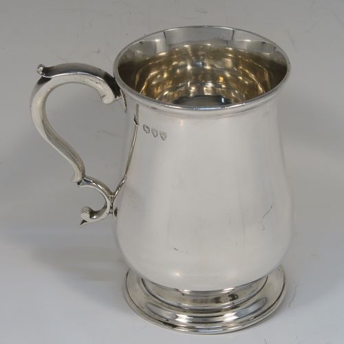 A very handsome Antique Victorian Sterling Silver half-pint tankard, having a plain round bellied body, a scroll handle with thumb-piece, and sitting on a pedestal foot. This elegant antique silver mug was made by Gibson and Langland of London in 1893. The dimensions of this fine hand-made antique silver pint mug or tankard are height 10 cms (4 inches), diameter at top 7 cms (2.75 inches), and it weighs approx. 191g (6.2 troy ounces).  