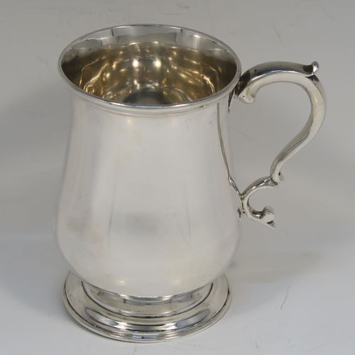 A very handsome Antique Victorian Sterling Silver half-pint tankard, having a plain round bellied body, a scroll handle with thumb-piece, and sitting on a pedestal foot. This elegant antique silver mug was made by Gibson and Langland of London in 1893. The dimensions of this fine hand-made antique silver pint mug or tankard are height 10 cms (4 inches), diameter at top 7 cms (2.75 inches), and it weighs approx. 191g (6.2 troy ounces).  