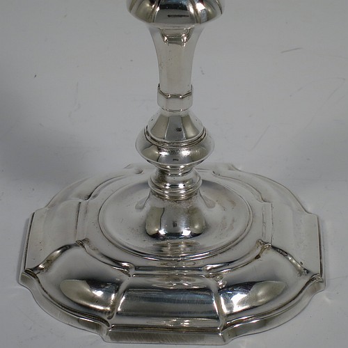 A cast Sterling Silver taper-stick, in a George I style, having a baluster body with hand-chased octagonal and reeded decoration. Made by Carrington and Co., of London in 1935. The dimensions of this fine hand-made silver taper-stick are height 14 cms (5.5 inches), width across base 9cms (3.5 inches) square, and it weighs approx. 209g (6.7 troy ounces). Please note that this taper-stick is cast and not filled, so the whole weight is silver.