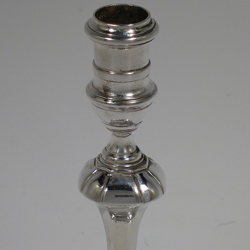 A cast Sterling Silver taper-stick, in a George I style, having a baluster body with hand-chased octagonal and reeded decoration. Made by Carrington and Co., of London in 1935. The dimensions of this fine hand-made silver taper-stick are height 14 cms (5.5 inches), width across base 9cms (3.5 inches) square, and it weighs approx. 209g (6.7 troy ounces). Please note that this taper-stick is cast and not filled, so the whole weight is silver.