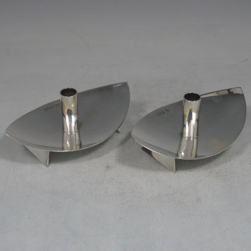    Pair of sterling silver 'Modernistic' tapersticks made by Cooper Brothers & Sons Ltd., of Sheffield in 1965. Length 12 cms, width 8 cms. Weight 6.5 troy ounces.