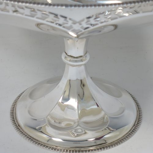 A very pretty Sterling Silver tazza dish, having a round body with an applied gadroon border above a lobed band of hand-pierced floral decoration, with two scroll side-handles, and all sitting on a matching pedestal foot. Made by Elkington and Co., of Birmingham in 1920. The dimensions of this fine hand-made silver tazza dish are height 18.5 cms (7.3 inches), diameter 21 cms (8.25 inches), and it weighs approx. 615g (19.8 troy ounces).   