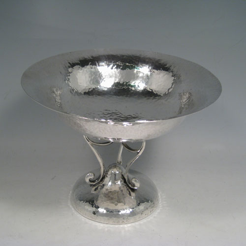    Antique Edwardian sterling silver Arts and Crafts tazza dish, having a round bowl sitting on a pedestal foot with scroll work, and an all-over hand-hammered plenished finish. Made by Walker and Hall of Sheffield in 1909. Height 15 cms (6 inches), diameter 20 cms (8 inches). Weight approx. 405g (13 troy ounces).