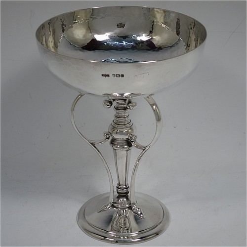 A very pretty Art Nouveau style Antique Edwardian Sterling Silver tazza dish or bowl, having a plain round bowl body with hand-hammered decoration, sitting on a pedestal foot with three scrolled side-handles. Made by James Dixon and Sons of Sheffield in 1905. The dimensions of this fine hand-made antique silver tazza bowl or dish are height 15 cms (6 inches), diameter of bowl 12 cms (4.75 inches), and it weighs approx. 272g (8.8 troy ounces).    