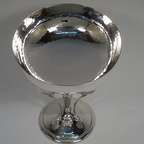 A very pretty Art Nouveau style Antique Edwardian Sterling Silver tazza dish or bowl, having a plain round bowl body with hand-hammered decoration, sitting on a pedestal foot with three scrolled side-handles. Made by James Dixon and Sons of Sheffield in 1905. The dimensions of this fine hand-made antique silver tazza bowl or dish are height 15 cms (6 inches), diameter of bowl 12 cms (4.75 inches), and it weighs approx. 272g (8.8 troy ounces).    