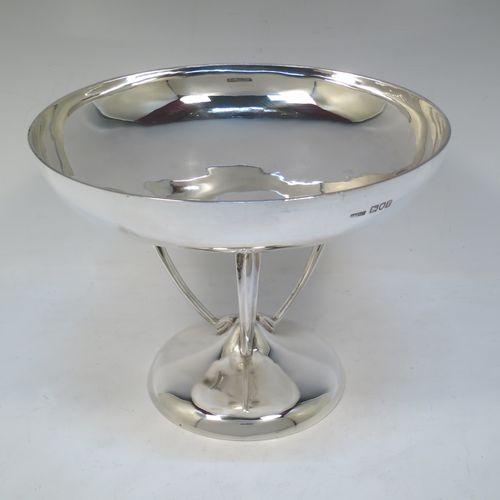 A pretty Art Nouveau style Antique Edwardian Sterling Silver tazza dish or bowl, having a plain round bowl body, sitting on a plain round pedestal foot with three scrolled supports. Made by Aspreys 
and Co. Ltd., of London in 1910. The dimensions of this fine hand-made antique silver tazza bowl or dish are height 17.5 cms (7 inches), diameter of bowl 23 cms (9 inches), and it weighs approx. 719g (23 troy ounces).   