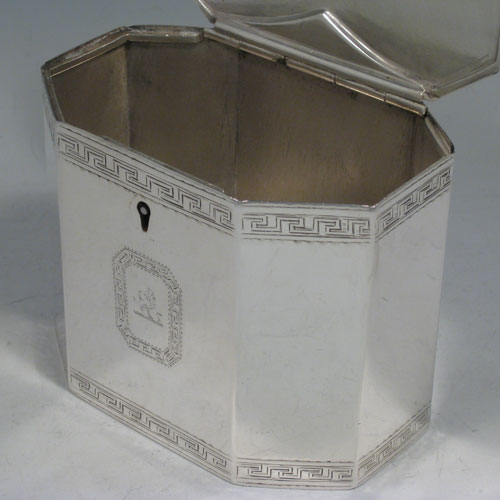 Antique Victorian sterling silver tea caddy box, having an octagonal straight-sided body, cast urn-shape finial sitting on a lid with flat hidden hinge, with hand-engraved neoclassical greek-key work, and an octagonal cartouche with crest. Made by John Edwards of London in 1854. Height 12 cms (4.75 inches), length 12 cms (4.75 inches), width 8 cms (3 inches). Weight approx. 449g (14.5 troy ounces).