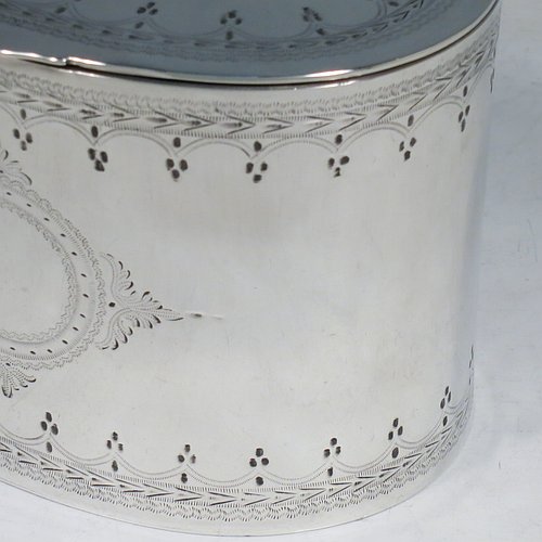 An Antique Victorian Silver Plated tea caddy box, having an oval straight-sided body, a flat lid with a hidden hinge, with hand-engraved bands of floral decoration top and bottom, together with two round  cartouches front and back, and sitting on a flat base. Made by the Mappin Brothers in ca. 1870. The dimensions of this fine hand-made antique silver-plated tea caddy box are height 9 cms (3.5 inches), length 12 cms (4.75 inches), and width 9 cms (3.5 inches).