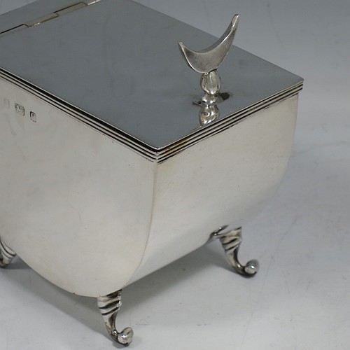 A very unusual Antique Edwardian Sterling Silver tea caddy box, having a plain U-shaped body with straight sides, a hinged lid with crescent shaped tea caddy spoon rest, a gold-gilt interior, and sitting on four cast scroll feet, together with a matching Old English pattern tea caddy spoon. Made by William Aitken of Birmingham in 1904 (the spoon made by Henry Atkins of Sheffield in 1918). The dimensions of this fine hand-made antique silver tea caddy box are height 7 cms (2.75 inches), length 9 cms (3.5 inches), width 6 cms (2.25 inches), and it weighs approx. 191g (6 troy ounces).