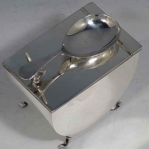 A very unusual Antique Edwardian Sterling Silver tea caddy box, having a plain U-shaped body with straight sides, a hinged lid with crescent shaped tea caddy spoon rest, a gold-gilt interior, and sitting on four cast scroll feet, together with a matching Old English pattern tea caddy spoon. Made by William Aitken of Birmingham in 1904 (the spoon made by Henry Atkins of Sheffield in 1918). The dimensions of this fine hand-made antique silver tea caddy box are height 7 cms (2.75 inches), length 9 cms (3.5 inches), width 6 cms (2.25 inches), and it weighs approx. 191g (6 troy ounces).