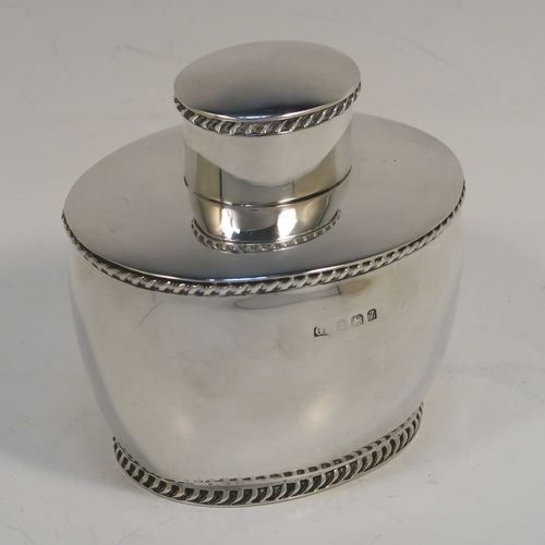 A very handsome Antique Sterling Silver tea caddy box, having an plain oval bellied body with applied gadroon borders, and a pull-off lid which was used as a measure, and all sitting on a flat base. This elegant silver tea caddy box was made by George Unite of Birmingham in 1924. The dimensions of this fine hand-made antique silver tea caddy box are height 8 cms (3.25 inches), length 8 cms (3.25 inches), width 6.5 cms (2.5 inches), and it weighs approx. 118g (3.8 troy ounces).   