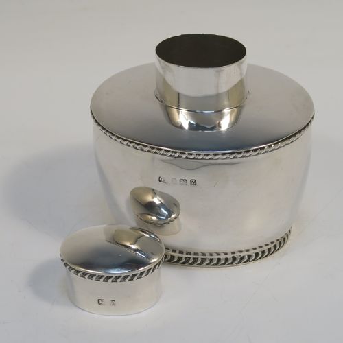 A very handsome Antique Sterling Silver tea caddy box, having an plain oval bellied body with applied gadroon borders, and a pull-off lid which was used as a measure, and all sitting on a flat base. This elegant silver tea caddy box was made by George Unite of Birmingham in 1924. The dimensions of this fine hand-made antique silver tea caddy box are height 8 cms (3.25 inches), length 8 cms (3.25 inches), width 6.5 cms (2.5 inches), and it weighs approx. 118g (3.8 troy ounces).   