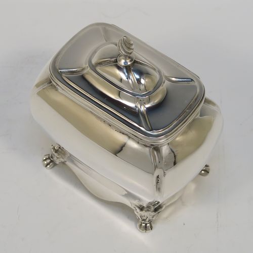 A very handsome Antique Sterling Silver tea caddy box in a Bon-bonier style, having a rectangular  bellied body with hand-chased fluted corners, a hinged domed lid with a cast swirl finial, a gold-gilt interior, and all sitting on four cast lions-paw feet. This elegant antique silver tea caddy box was made by S. Blanckensee and Sons of Chester in 1921. The dimensions of this fine hand-made antique silver tea caddy box are height 11 cms (4.3 inches), depth 6.5 cms (2.6 inches), width 9.5 cms (3.75 inches), and it weighs approx. 186g (6 troy ounces).   