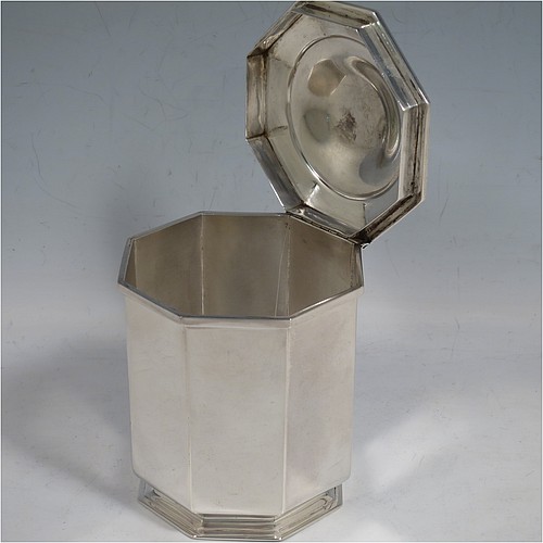 An Antique Edwardian Sterling Silver tea caddy box, having a plain straight-sided octagonal body, a hinged lid with cast urn-shape finial, and all sitting on a collet foot. Made by Elkington & Co., of London in 1908. The dimensions of this fine hand-made antique silver tea caddy box are height 13 cms (5 inches), width 9 cms (3.5 inches), and it weighs approx. 312g (10 troy ounces).    