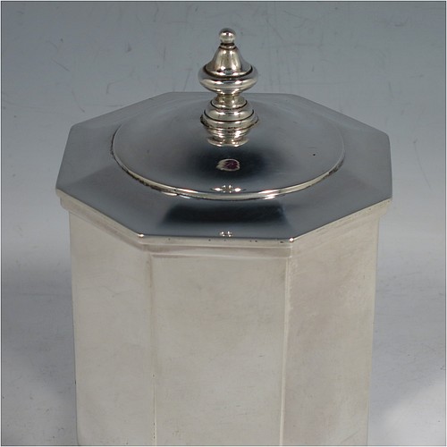 An Antique Edwardian Sterling Silver tea caddy box, having a plain straight-sided octagonal body, a hinged lid with cast urn-shape finial, and all sitting on a collet foot. Made by Elkington & Co., of London in 1908. The dimensions of this fine hand-made antique silver tea caddy box are height 13 cms (5 inches), width 9 cms (3.5 inches), and it weighs approx. 312g (10 troy ounces).    