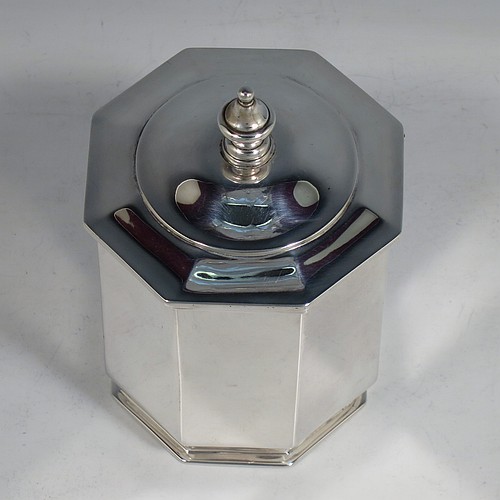 An Antique Edwardian Sterling Silver tea caddy box, having a plain straight-sided octagonal body, a hinged lid with cast urn-shape finial, and all sitting on a collet foot. Made by Elkington & Co., of London in 1908. The dimensions of this fine hand-made antique silver tea caddy box are height 13 cms (5 inches), width 9 cms (3.5 inches), and it weighs approx. 312g (10 troy ounces).    