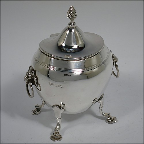 An Antique Edwardian Sterling Silver tea caddy box, having a plain oval bellied body with an upper band of hand-chased reeded decoration, a hinged lid with a cast swirl finial, with two cast lions-head ring side-handles, a gold-gilt interior, and sitting on four cast hoof feet with trefoil shoulders. Made by Nathan and Hayes of Chester in 1906. The dimensions of this fine hand-made antique silver tea caddy box are height 11.5 cms (4.5 inches), width 9 cms (3.5 inches), depth 6.5 cms (2.5 inches), and it weighs approx. 167g (5.4 troy ounces).    