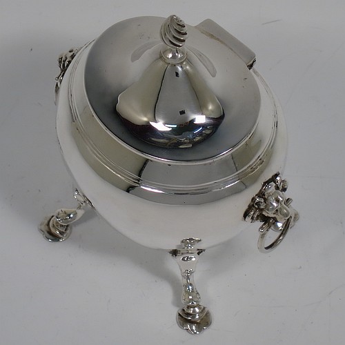 An Antique Edwardian Sterling Silver tea caddy box, having a plain oval bellied body with an upper band of hand-chased reeded decoration, a hinged lid with a cast swirl finial, with two cast lions-head ring side-handles, a gold-gilt interior, and sitting on four cast hoof feet with trefoil shoulders. Made by Nathan and Hayes of Chester in 1906. The dimensions of this fine hand-made antique silver tea caddy box are height 11.5 cms (4.5 inches), width 9 cms (3.5 inches), depth 6.5 cms (2.5 inches), and it weighs approx. 167g (5.4 troy ounces).    