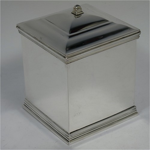 An Antique Edwardian Sterling Silver tea caddy box, having a plain square shaped body with plain straight sides and applied reeded top and bottom borders, a hinged stepped lid with a finial, and all sitting on a flat base. Made by Holland, Aldwinckle, and Slater of London in 1910. The dimensions of this fine hand-made antique silver tea caddy box are height 11 cms (4.25 inches), width 8 cms (3 inches) square, and it weighs approx. 417g (13.5 troy ounces).    