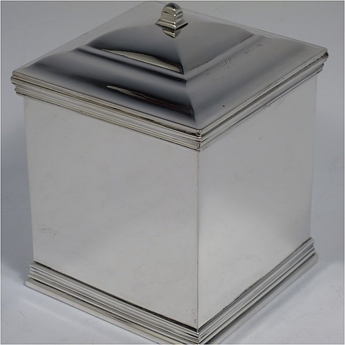 An Antique Edwardian Sterling Silver tea caddy box, having a plain square shaped body with plain straight sides and applied reeded top and bottom borders, a hinged stepped lid with a finial, and all sitting on a flat base. Made by Holland, Aldwinckle, and Slater of London in 1910. The dimensions of this fine hand-made antique silver tea caddy box are height 11 cms (4.25 inches), width 8 cms (3 inches) square, and it weighs approx. 417g (13.5 troy ounces).    