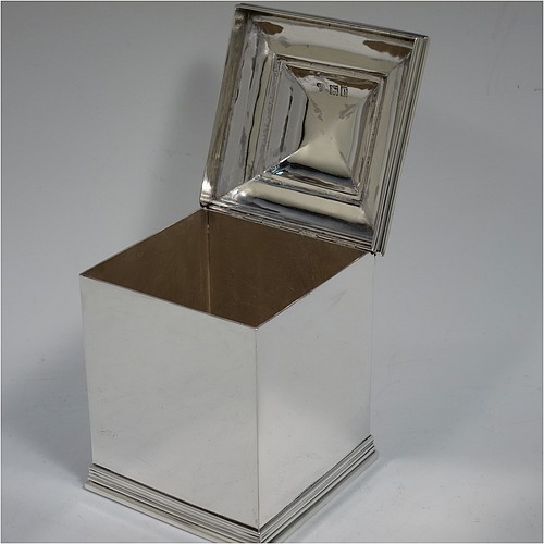 An Antique Edwardian Sterling Silver tea caddy box, having a plain square shaped body with plain straight sides and applied reeded top and bottom borders, a hinged stepped lid with a finial, and all sitting on a flat base. Made by Holland, Aldwinckle, and Slater of London in 1910. The dimensions of this fine hand-made antique silver tea caddy box are height 11 cms (4.25 inches), width 8 cms (3 inches) square, and it weighs approx. 417g (13.5 troy ounces).    