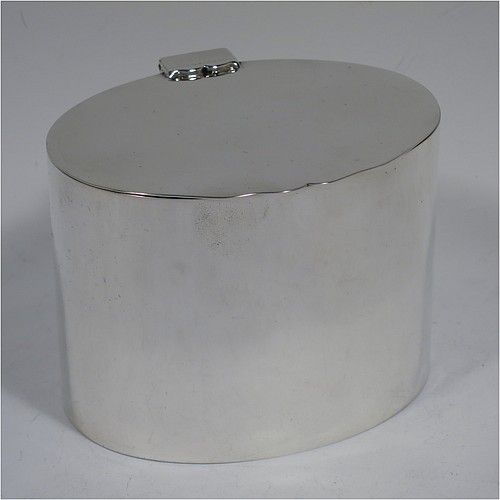 A very stylish Antique Victorian Sterling Silver tea caddy box, having a very plain oval body with straight sides, a flat hinged plain lid with shaped thumb-piece, and sitting on a flat base. Made by William Hutton of London in 1893. The dimensions of this fine hand-made antique silver tea caddy box are height 8 cms (3 inches), length 10 cms (4 inches), depth 8 cms (3 inches), and it weighs approx. 185g (6 troy ounces).    