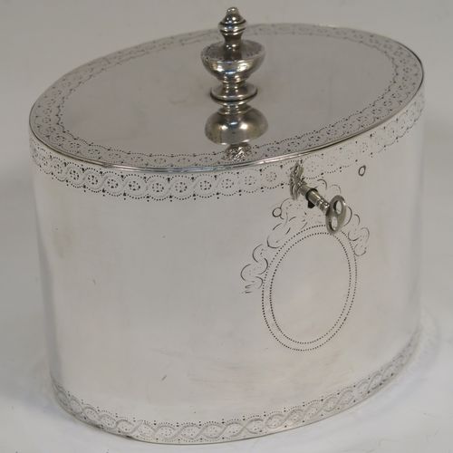 A very handsome Antique Georgian Sterling Silver tea caddy box, having an oval straight-sided body with an upper and lower band of hand-engraved floral decoration, a cast urn-shaped finial attached to a lid with flat hidden hinge and matching decoration, with original lock and key. This elegant antique silver tea caddy box was made by Joseph Preedy of London in 1778. The dimensions of this fine hand-made antique tea caddy box are height 11 cms (4.25 inches), length 12 cms (4.75 inches), width 9 cms (3.5 inches), and it weighs approx. 350g (11.3 troy ounces).   