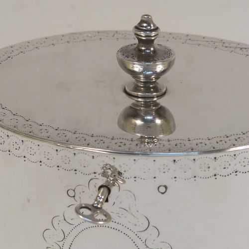 A very handsome Antique Georgian Sterling Silver tea caddy box, having an oval straight-sided body with an upper and lower band of hand-engraved floral decoration, a cast urn-shaped finial attached to a lid with flat hidden hinge and matching decoration, with original lock and key. This elegant antique silver tea caddy box was made by Joseph Preedy of London in 1778. The dimensions of this fine hand-made antique tea caddy box are height 11 cms (4.25 inches), length 12 cms (4.75 inches), width 9 cms (3.5 inches), and it weighs approx. 350g (11.3 troy ounces).   