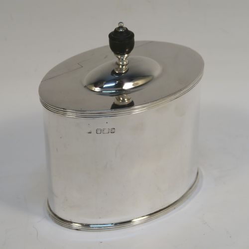 A handsome Antique Victorian Sterling Silver tea caddy box, in a neoclassical style having a plain oval straight-sided body, with applied reeded borders, a wooden urn-shaped finial sitting on a lid with a flat hidden invisible hinge, and all sitting on a flat base. This elegant antique silver tea caddy box was made by Fordnam and Faulkner of Sheffield in 1898. The dimensions of this fine hand-made silver tea caddy box are height 10 cms (4 inches), length 10 cms (4 inches), depth 7 cms (2.75 inches), and it weighs approx. 240g (7.7 troy ounces).   