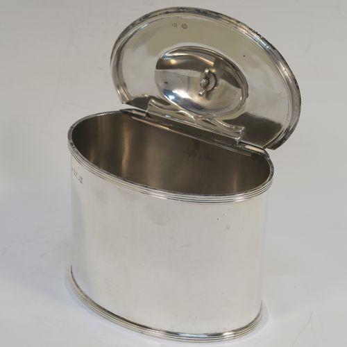 A handsome Antique Victorian Sterling Silver tea caddy box, in a neoclassical style having a plain oval straight-sided body, with applied reeded borders, a wooden urn-shaped finial sitting on a lid with a flat hidden invisible hinge, and all sitting on a flat base. This elegant antique silver tea caddy box was made by Fordnam and Faulkner of Sheffield in 1898. The dimensions of this fine hand-made silver tea caddy box are height 10 cms (4 inches), length 10 cms (4 inches), depth 7 cms (2.75 inches), and it weighs approx. 240g (7.7 troy ounces).   