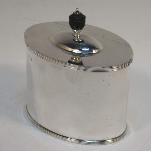 A handsome Antique Victorian Sterling Silver tea caddy box, in a neoclassical style having a plain oval straight-sided body, with applied reeded borders, a wooden urn-shaped finial sitting on a lid with a flat hidden invisible hinge, and all sitting on a flat base. This elegant antique silver tea caddy box was made by Fordnam and Faulkner of Sheffield in 1898. The dimensions of this fine hand-made silver tea caddy box are height 10 cms (4 inches), length 10 cms (4 inches), depth 7 cms (2.75 inches), and it weighs approx. 240g (7.7 troy ounces).   