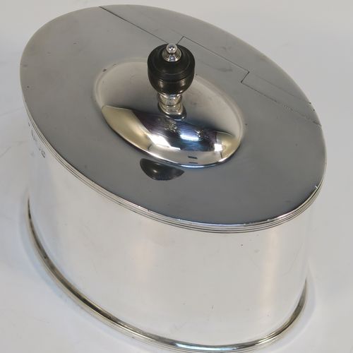 A handsome Antique Victorian Sterling Silver tea caddy box, in a neoclassical style having a plain oval straight-sided body, with applied reeded borders, a wooden urn-shaped finial sitting on a lid with a flat hidden invisible hinge, and all sitting on a flat base. This elegant antique silver tea caddy box was made by Fordnam and Faulkner of Sheffield in 1898. The dimensions of this fine hand-made silver tea caddy box are height 10 cms (4 inches), length 10 cms (4 inches), depth 7 cms (2.75 inches), and it weighs approx. 240g (7.7 troy ounces).   