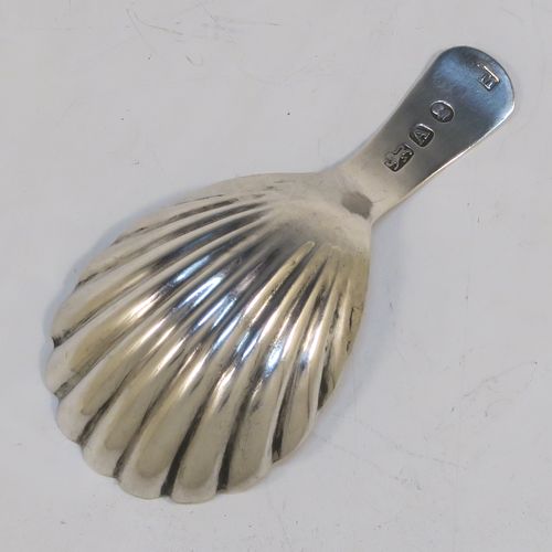 A very handsome Antique Georgian Sterling Silver tea caddy spoon, having a hand-engraved curved handle, and a hand-chased shell style oval bowl. This elegant antique silver tea caddy spoon was made in London in 1796. The dimensions of this fine hand-made antique silver tea caddy spoon are length 7 cms (2.75 inches), width 3.5 cms (1.3 inches), and it weighs approx. 6g (0.2 troy ounces).   