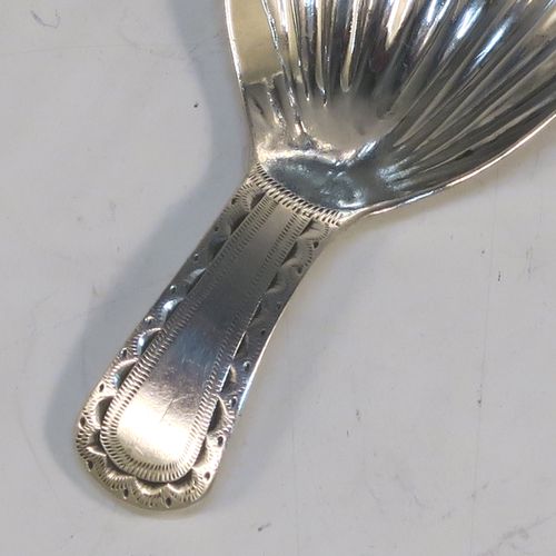 A very handsome Antique Georgian Sterling Silver tea caddy spoon, having a hand-engraved curved handle, and a hand-chased shell style oval bowl. This elegant antique silver tea caddy spoon was made in London in 1796. The dimensions of this fine hand-made antique silver tea caddy spoon are length 7 cms (2.75 inches), width 3.5 cms (1.3 inches), and it weighs approx. 6g (0.2 troy ounces).   