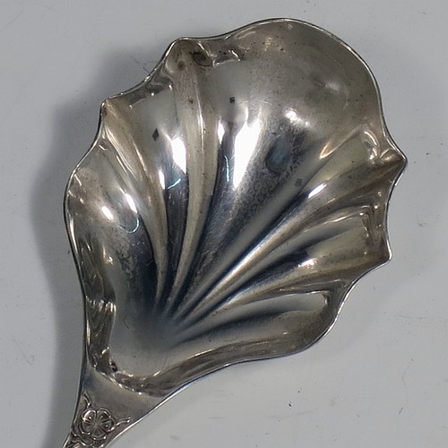 An Antique Edwardian Sterling Silver tea caddy spoon, having a hand-chased handle with floral decoration, a heart-shaped vacant cartouche, and a hand-chased fluted oval bowl. Made by Montague Friedlander of Chester in 1906. The dimensions of this fine hand-made antique silver tea caddy spoon are length 9.5 cms (3.75 inches), width across bowl 4 cms (1.5 inches), and it weighs approx. 16g (0.5 troy ounces).