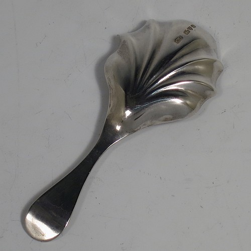 An Antique Edwardian Sterling Silver tea caddy spoon, having a hand-chased handle with floral decoration, a heart-shaped vacant cartouche, and a hand-chased fluted oval bowl. Made by Montague Friedlander of Chester in 1906. The dimensions of this fine hand-made antique silver tea caddy spoon are length 9.5 cms (3.75 inches), width across bowl 4 cms (1.5 inches), and it weighs approx. 16g (0.5 troy ounces).