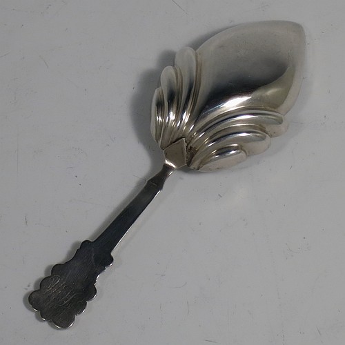 An Antique Georgian Sterling Silver tea caddy spoon, having a hand-chased handle with reeded anthemion leaf floral decoration, and a hand-chased fluted oval pointed bowl. Made by Thomas Fowke of London in 1831. The dimensions of this fine hand-made antique silver tea caddy spoon are length 10 cms (4 inches), width across bowl 3.5 cms (1.3 inches), and it weighs approx. 8g (0.25 troy ounces).