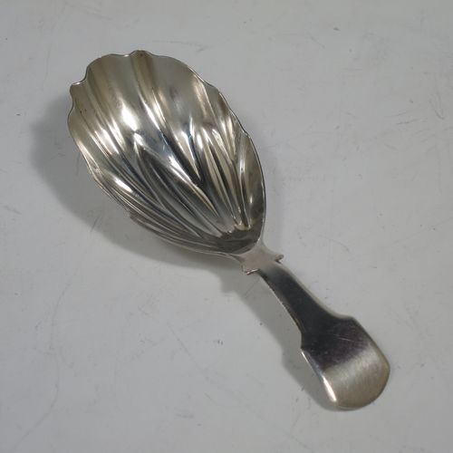 An Antique Georgian Sterling Silver tea caddy spoon, having a plain Fiddle pattern handle, and a hand-chased fluted oval bowl. Made by Francis Parsons of Exeter in 1819. The dimensions of this fine hand-made antique silver tea caddy spoon are length 9 cms (3.5 inches), width across bowl 3 cms (1.25 inches), and it weighs approx. 10g (0.3 troy ounces).   