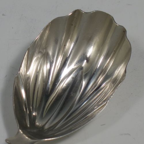 An Antique Georgian Sterling Silver tea caddy spoon, having a plain Fiddle pattern handle, and a hand-chased fluted oval bowl. Made by Francis Parsons of Exeter in 1819. The dimensions of this fine hand-made antique silver tea caddy spoon are length 9 cms (3.5 inches), width across bowl 3 cms (1.25 inches), and it weighs approx. 10g (0.3 troy ounces).   