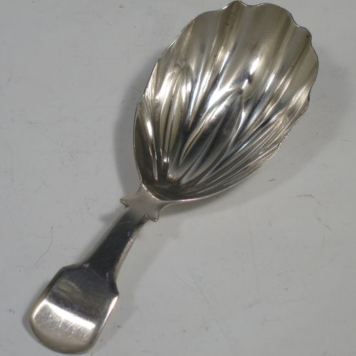 An Antique Georgian Sterling Silver tea caddy spoon, having a plain Fiddle pattern handle, and a hand-chased fluted oval bowl. Made by Francis Parsons of Exeter in 1819. The dimensions of this fine hand-made antique silver tea caddy spoon are length 9 cms (3.5 inches), width across bowl 3 cms (1.25 inches), and it weighs approx. 10g (0.3 troy ounces).   