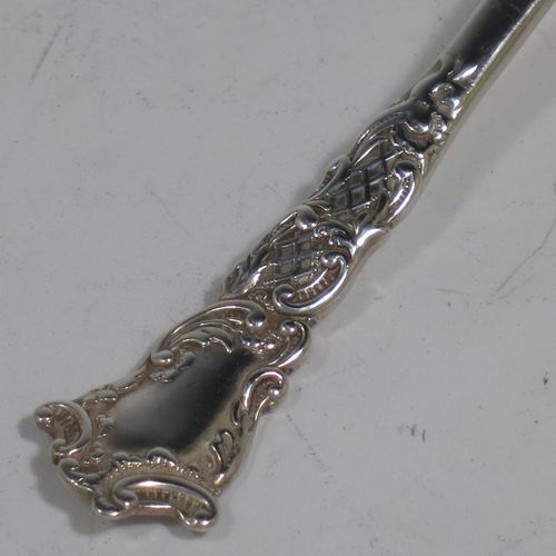 An Antique Sterling Silver tea caddy spoon, with a floral patterned handle, and a hand-chased oval bowl with scroll decoration. Made by Joseph Gloster of Birmingham in 1911. The dimensions of this fine hand-made antique silver tea caddy spoon are length 10 cms (4 inches), width across bowl 3.5 cms (1.3 inches), and it weighs approx. 18g (0.6 troy ounces).    