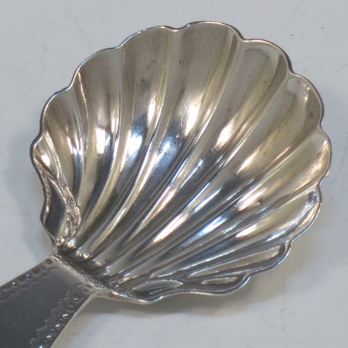 A very elegant Antique Georgian Sterling Silver tea caddy spoon, having an engraved curved handle, and a hand-chased shell style round bowl. Made in London in 1785, with the rare Incuse Duty Mark. The dimensions of this fine hand-made antique silver tea caddy spoon are length 7 cms (2.75 inches), width 4 cms (1.5 inches), and it weighs approx. 9g (0.3 troy ounces). Please note that this item is monogrammed.