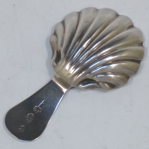 A very elegant Antique Georgian Sterling Silver tea caddy spoon, having an engraved curved handle, and a hand-chased shell style round bowl. Made in London in 1785, with the rare Incuse Duty Mark. The dimensions of this fine hand-made antique silver tea caddy spoon are length 7 cms (2.75 inches), width 4 cms (1.5 inches), and it weighs approx. 9g (0.3 troy ounces). Please note that this item is monogrammed.