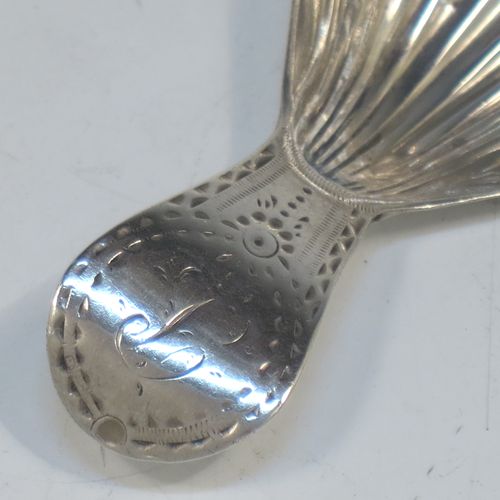 A very elegant Antique Georgian Sterling Silver tea caddy spoon, having an engraved curved handle, and a hand-chased shell style oval bowl. Made in London in 1788. The dimensions of this fine hand-made antique silver tea caddy spoon are length 7 cms (2.75 inches), width 3.5 cms (1.3 inches), and it weighs approx. 11g (0.4 troy ounces). Please note that this item is monogrammed.   